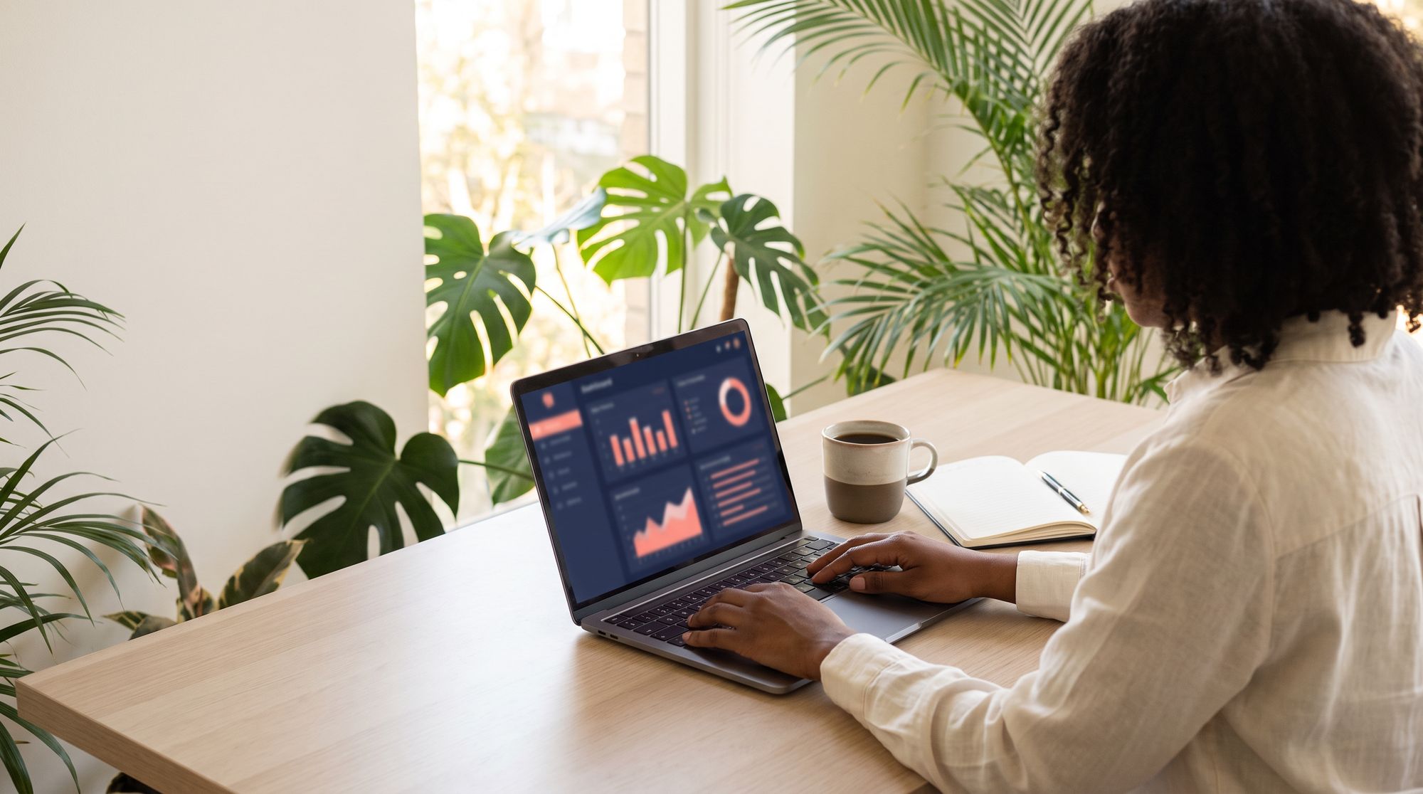 An organizer at her desk by a sunny window follows registrations and payments on a live dashboard.